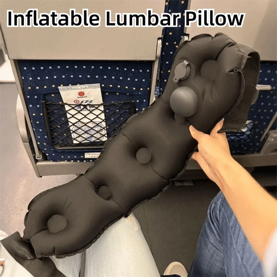 Black inflatable Relvie lumbar cushion held beside a train seat, with strap and valve visible