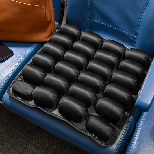 Black Relvie inflatable seat cushion with 24 air cells on a blue airplane seat